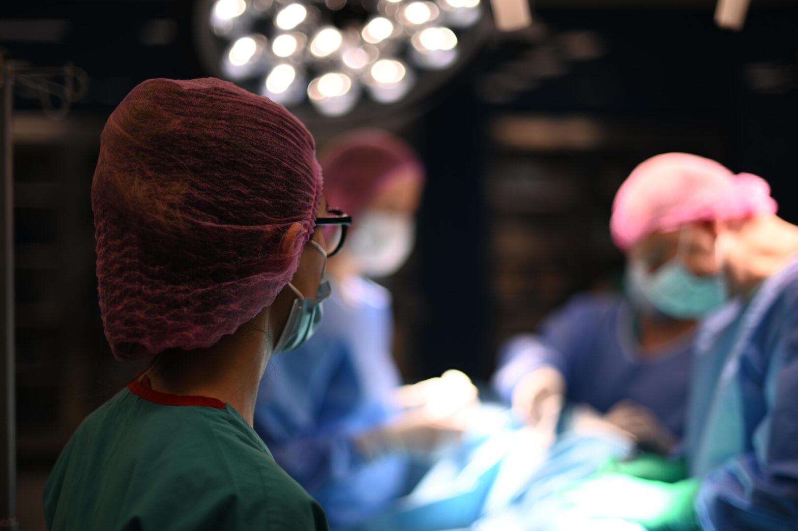 Over-the-shoulder,View,Of,A,Female,Surgeon,Or,Nurse,Wearing,A Over-the-shoulder,View,Of,A,Female,Surgeon,Or,Nurse,Wearing,A